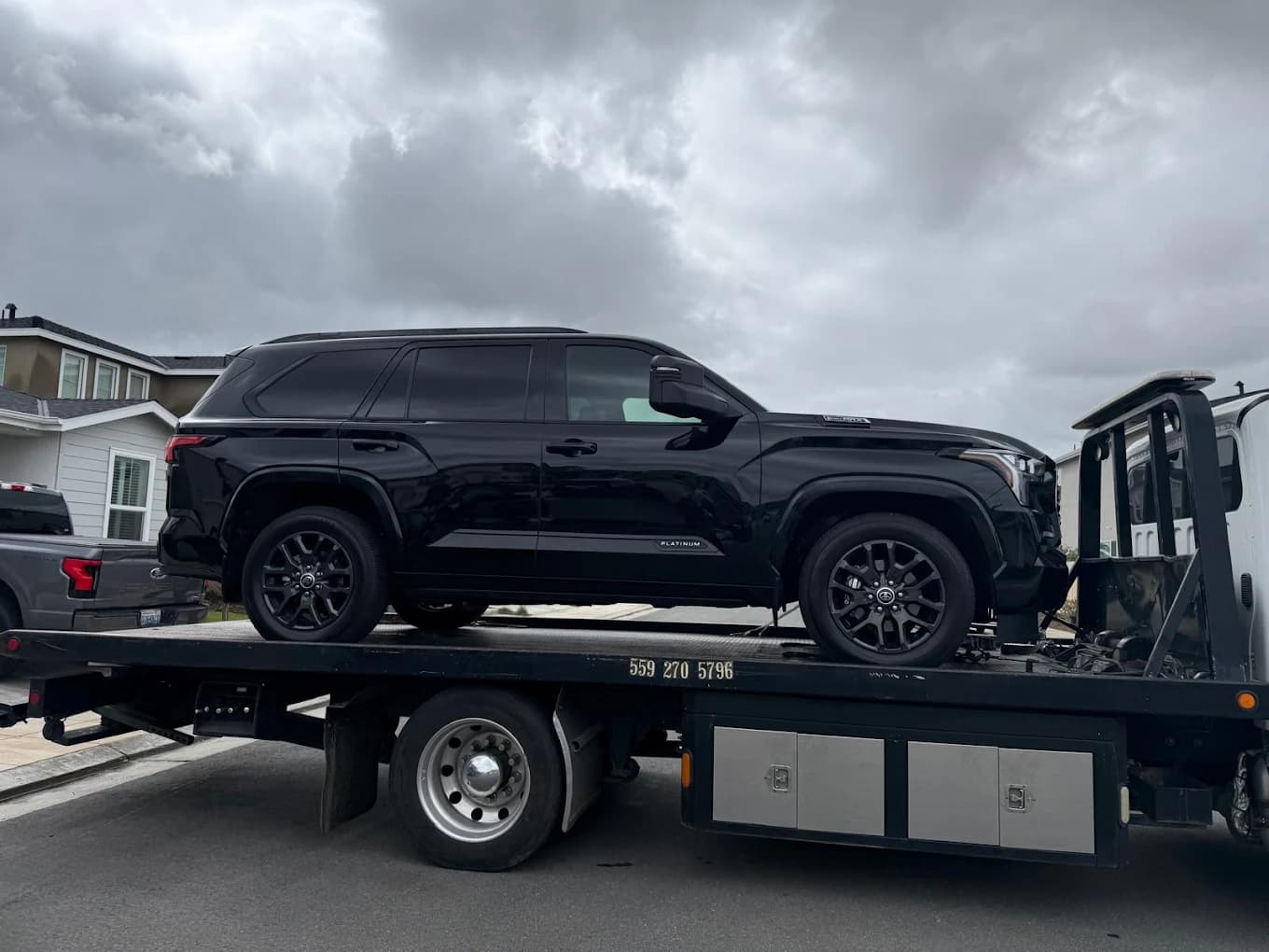 Black SUV secured on a Shako Towing flatbed